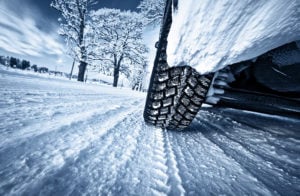 image of car driving on snow packed road pov tire